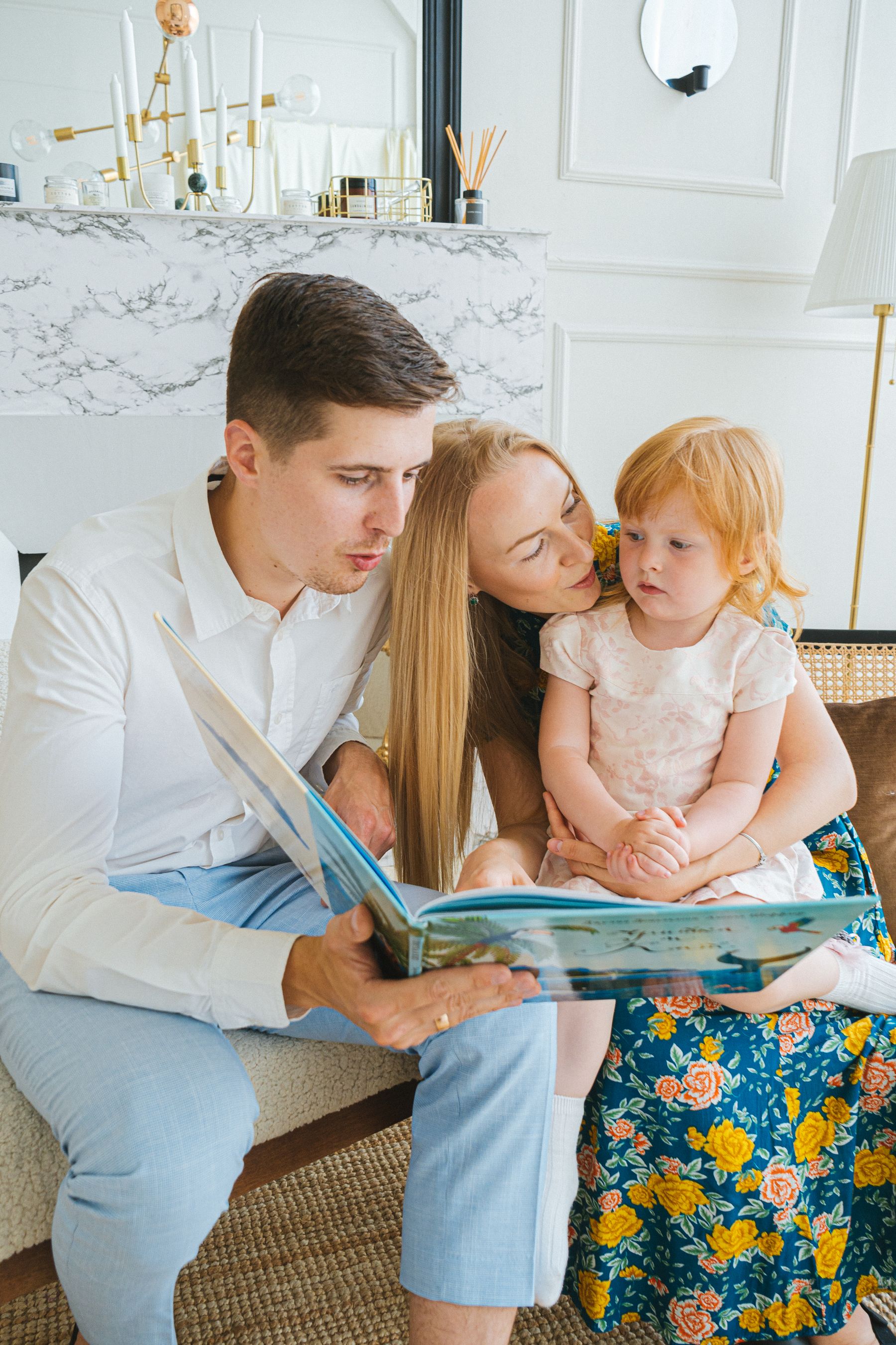 Parents and child sharing a book